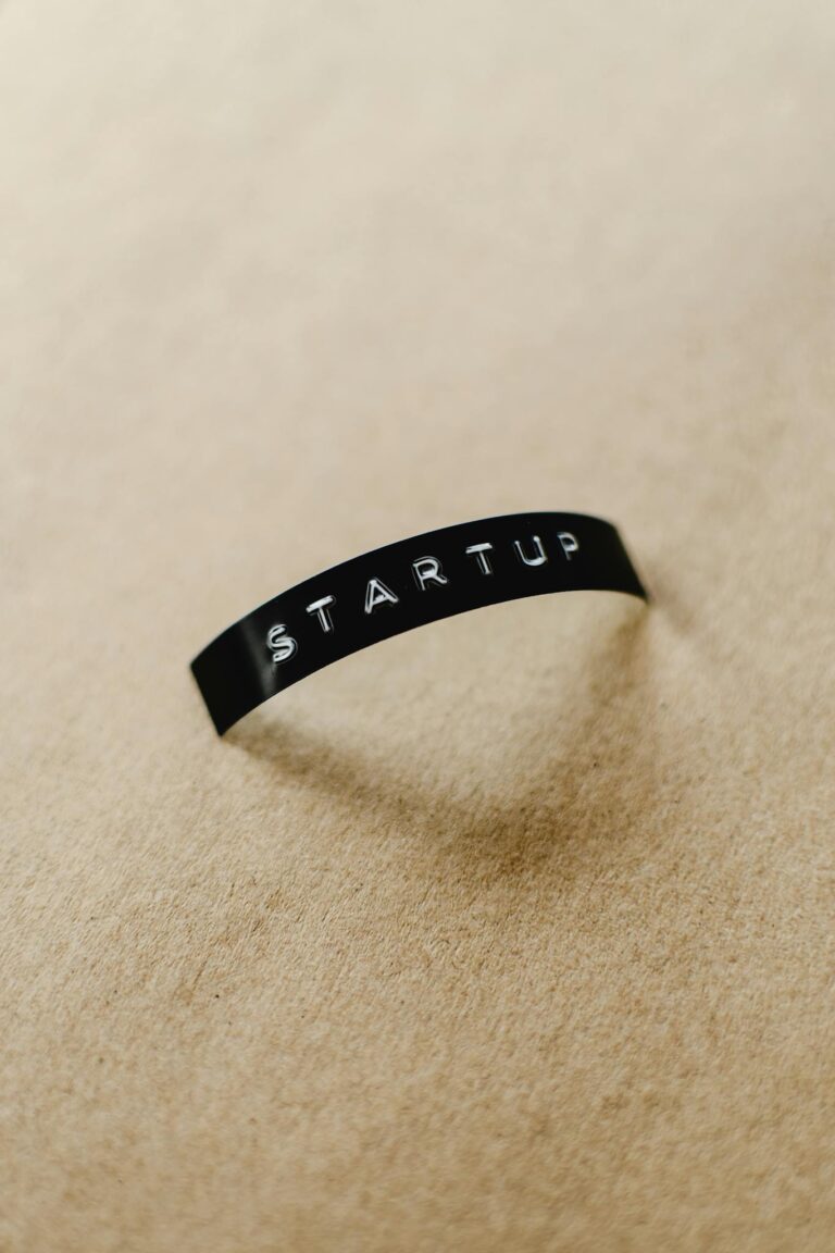 Close-up of a black label with 'STARTUP' text on a beige background, perfect for conceptual business themes.